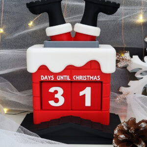 Red and white countdown calendar shaped like a snowy chimney with Santa's black boots sticking out and white numbers showing 31, surrounded by pinecones, a silver bauble, a wooden snowflake ornament, and warm fairy lights.
