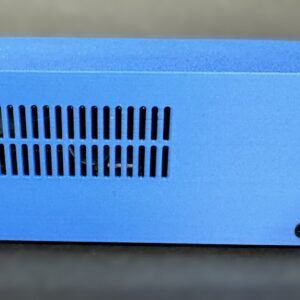 Side view of a small rectangular blue electronic enclosure with two rows of vertical ventilation slots near the left center and black screws near the bottom corners against a blurred background.