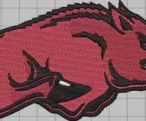 Embroidered-style stylized red hog with black outline and white tusks in a snarling, charging pose on a light gray grid background.